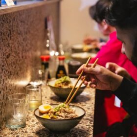 eating noodles at noodle bar